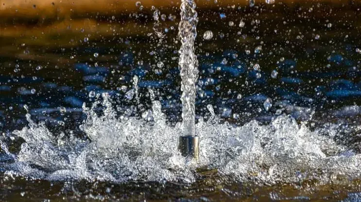 Close-up of a water fountain's splash, droplets catching the light, offering a calm and quieter moment.




