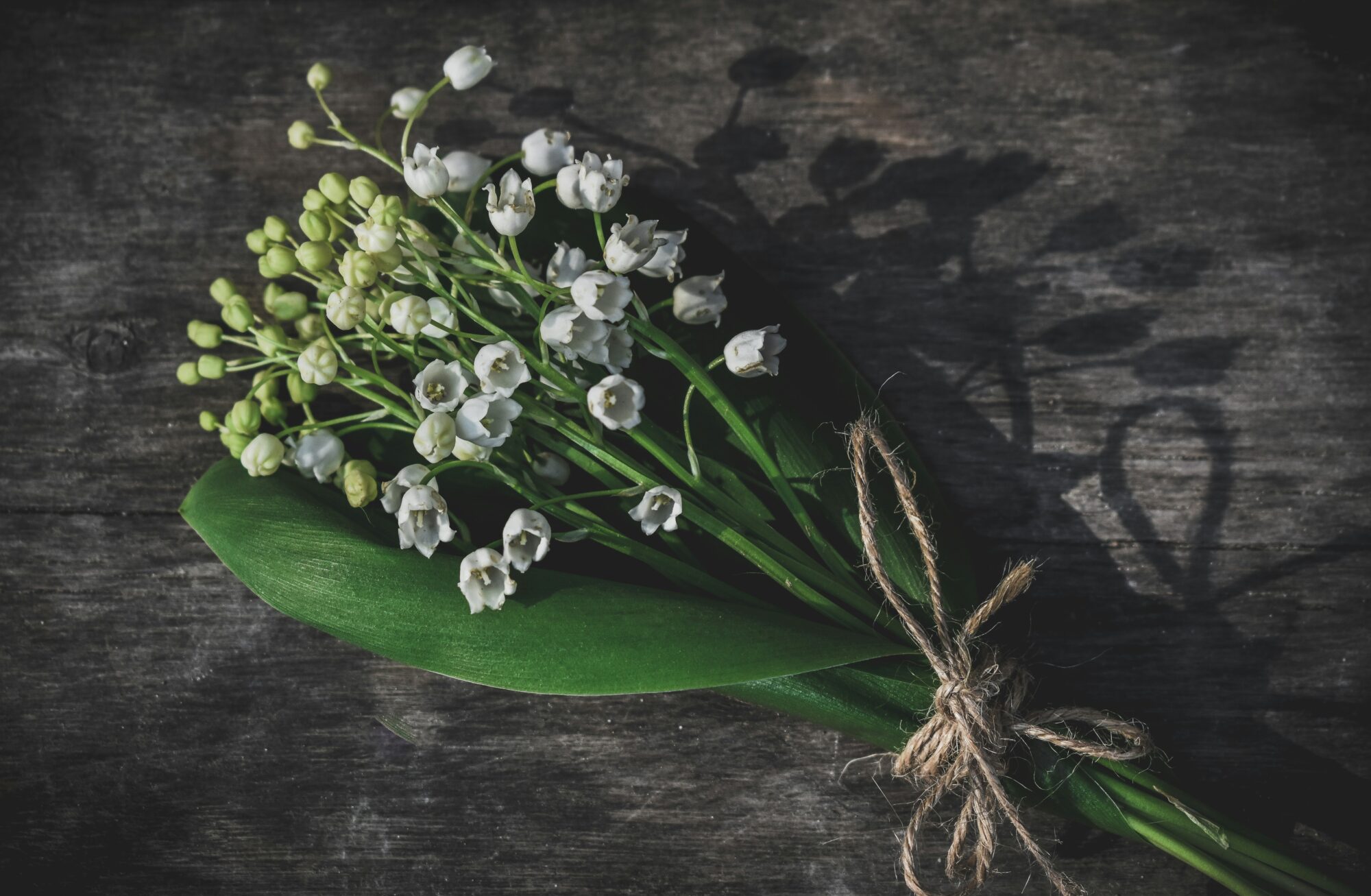 lily of the valley represents sadness, this is a tied bouquet.